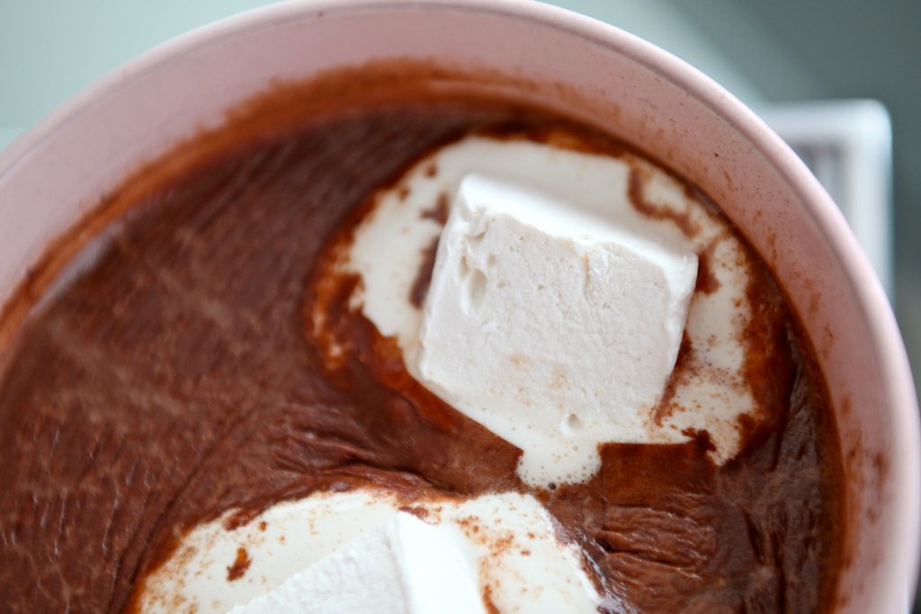 Mug of rich hot chocolate topped with melting marshmallows