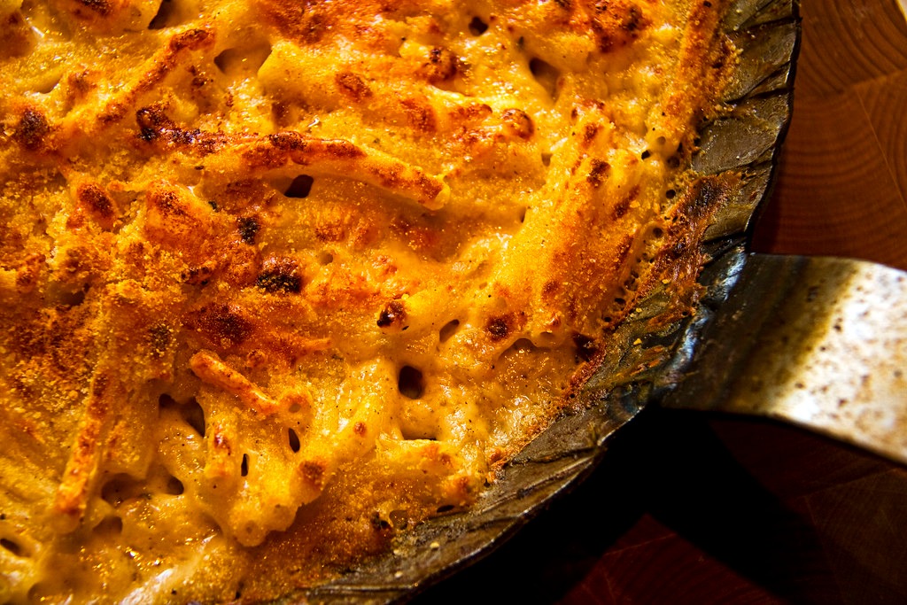 Pan of baked macaroni and cheese with a golden crumb crust