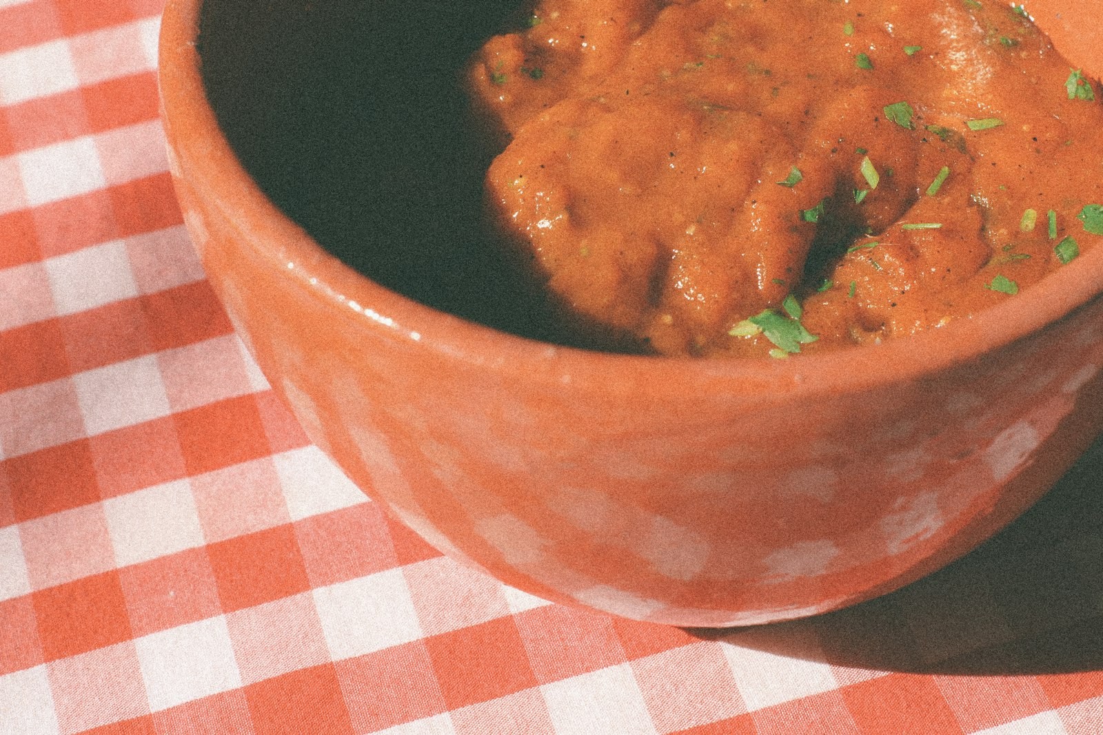 Bowl of warm marinara dipping sauce with herbs