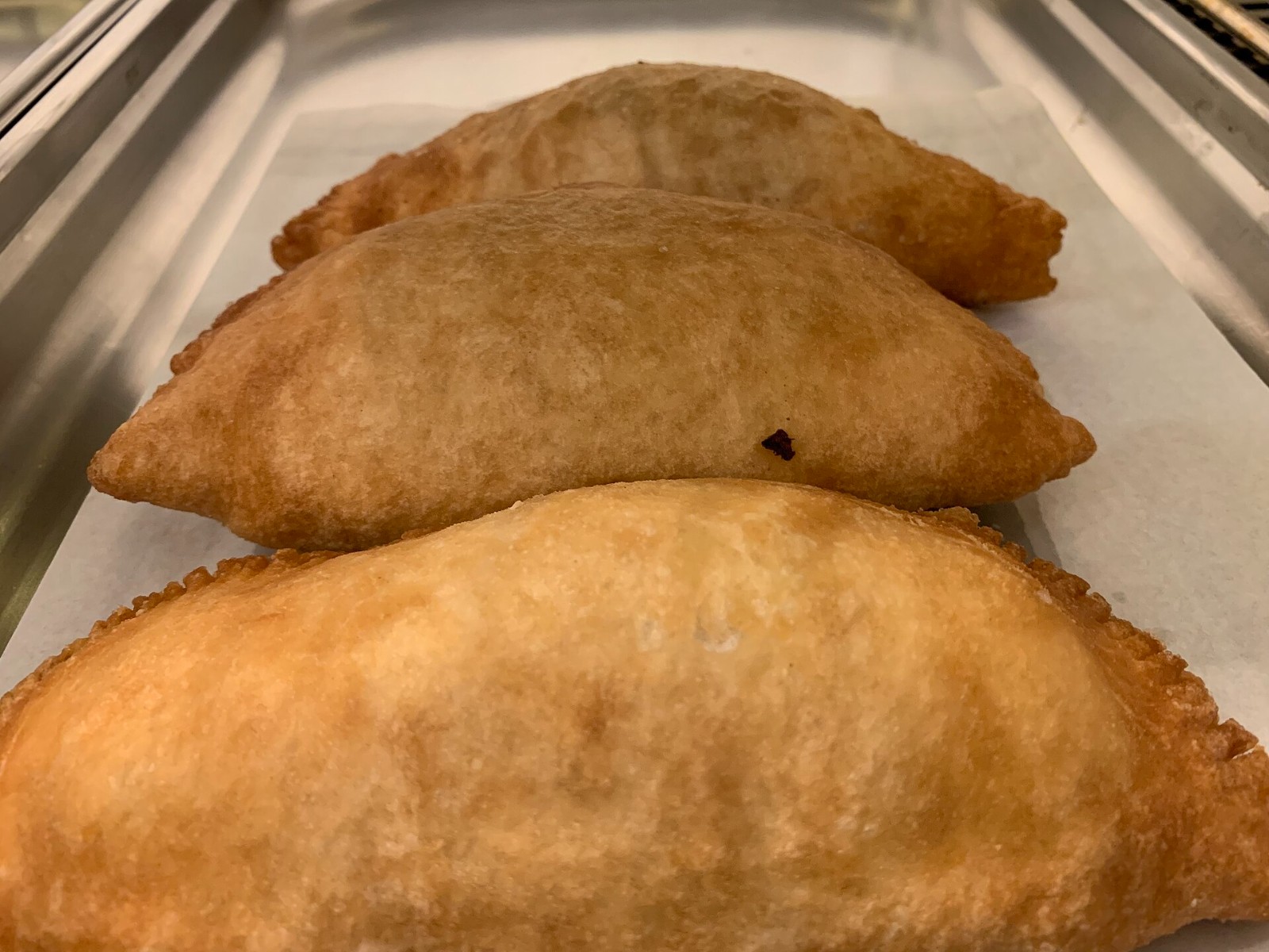 Golden fried panzerotti on a tray