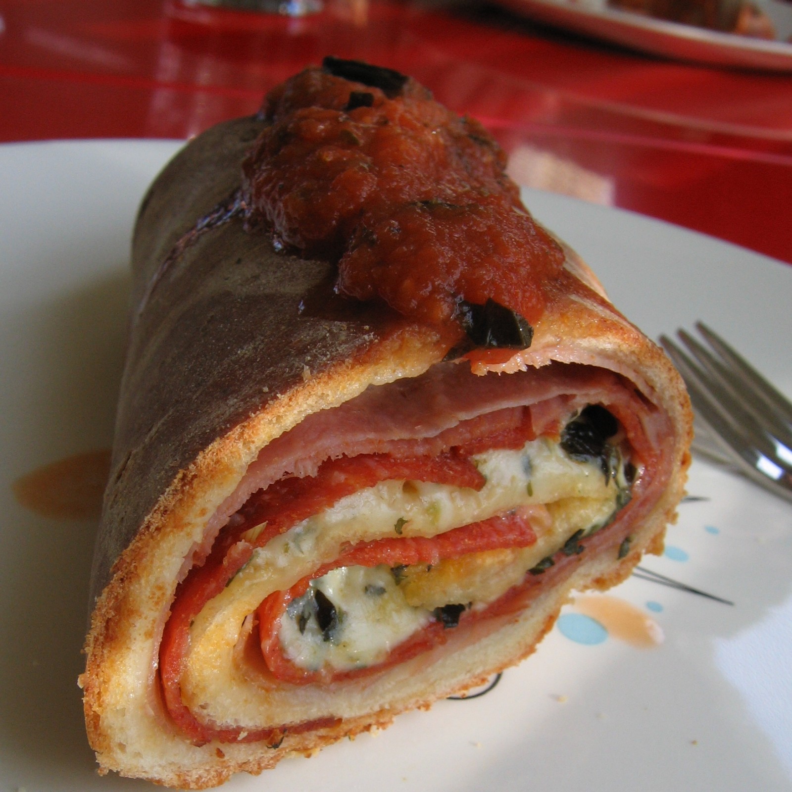 Sliced pepperoni stromboli showing layers of cheese and pepperoni