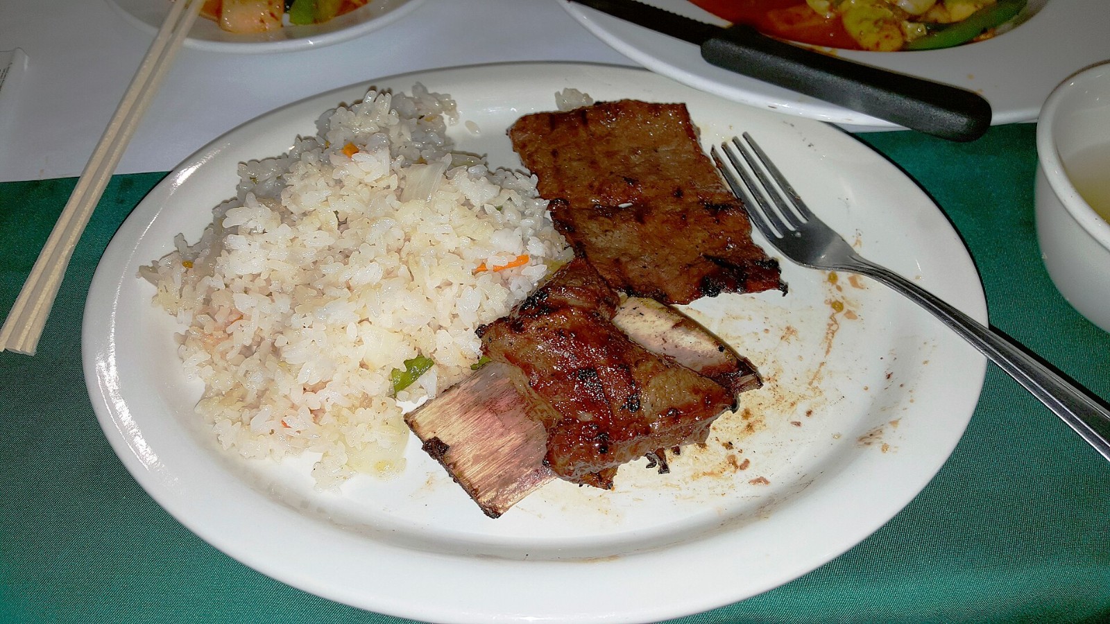 Korean style grilled beef short ribs with white rice on a plate