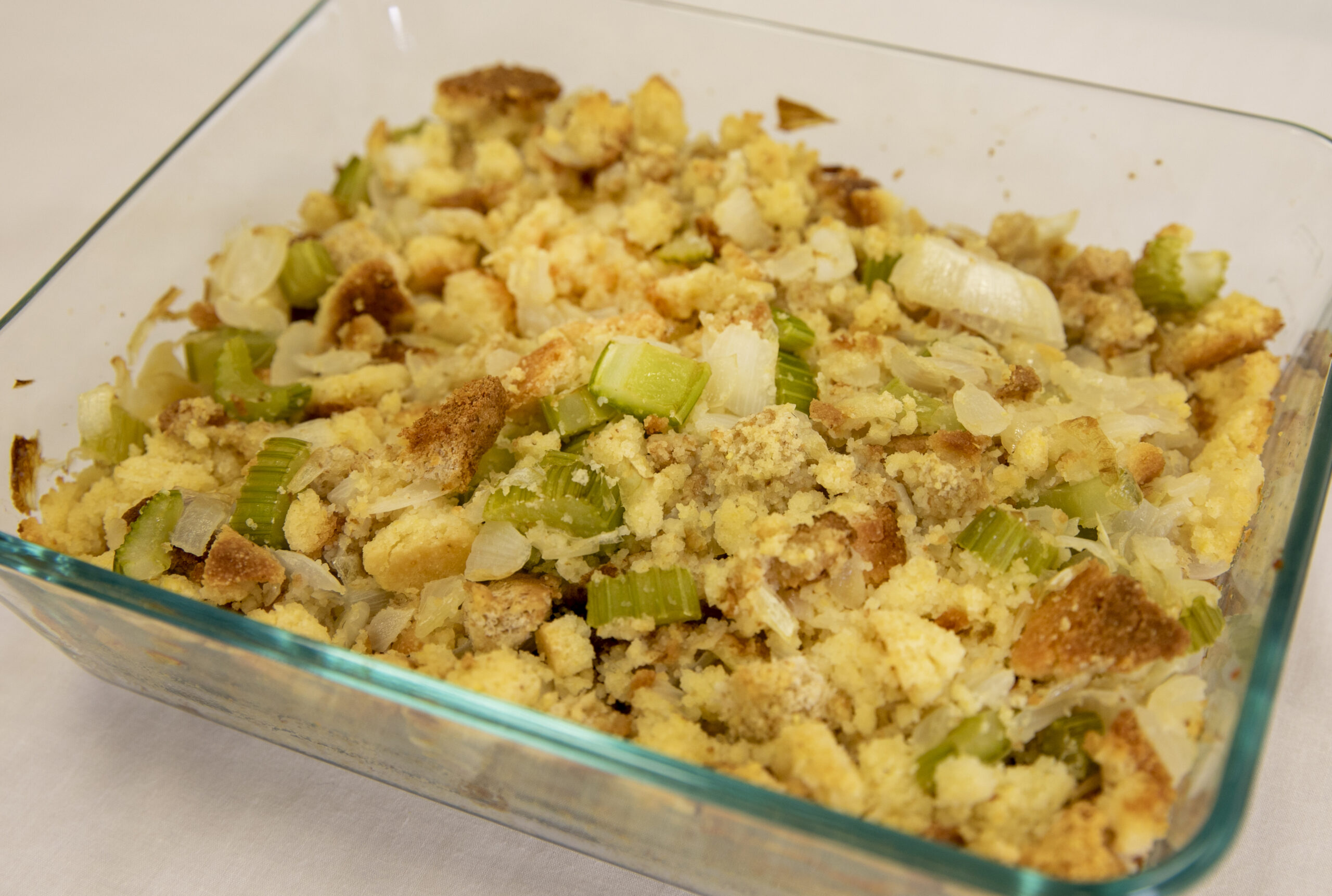 Cornbread dressing baked in a glass dish