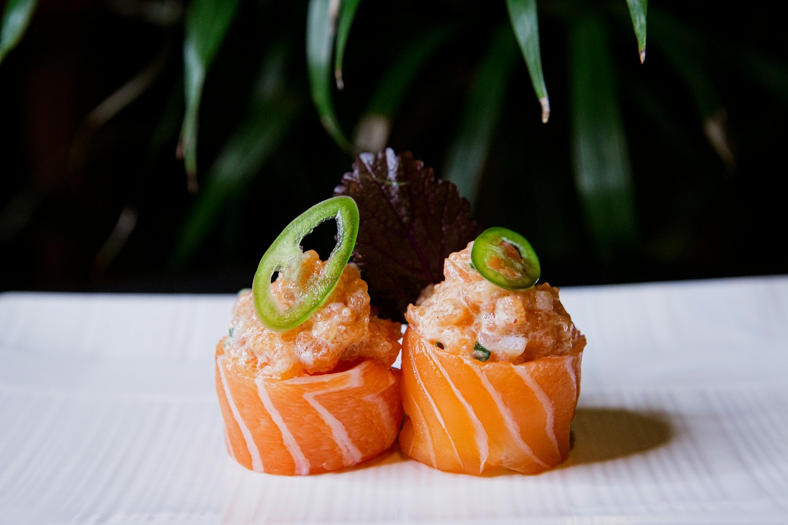 Crispy rice salmon bites topped with jalapeno slices