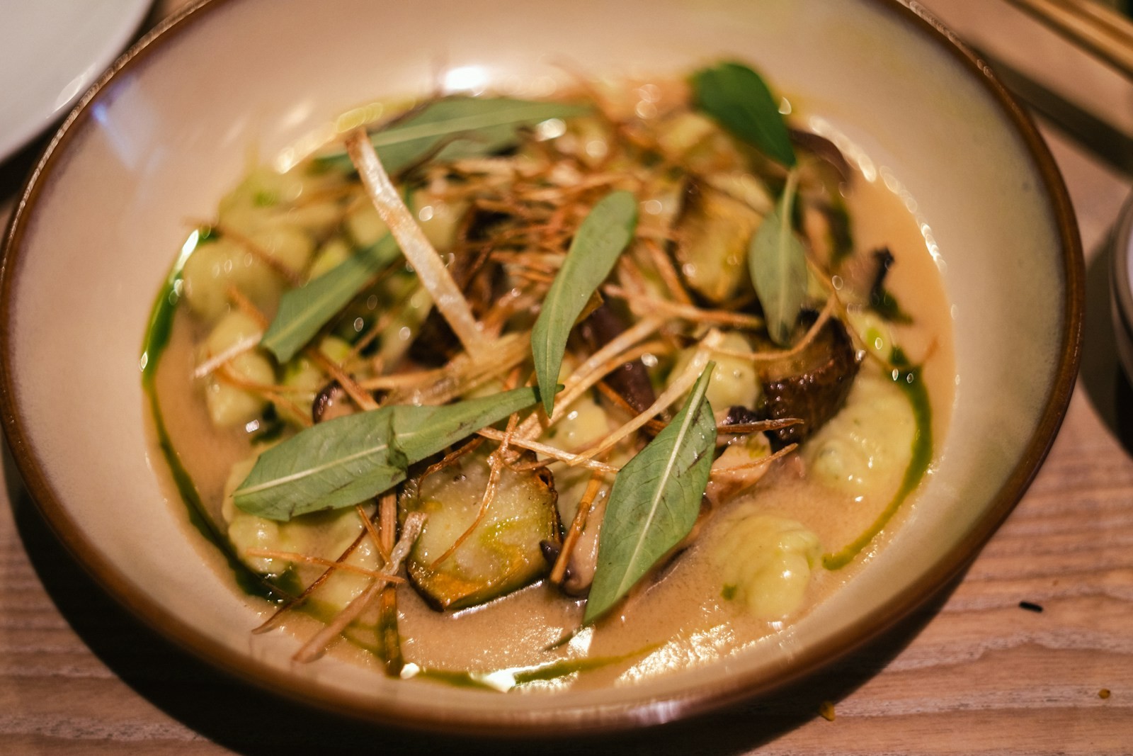 Crispy gnocchi with zucchini and basil in a bowl