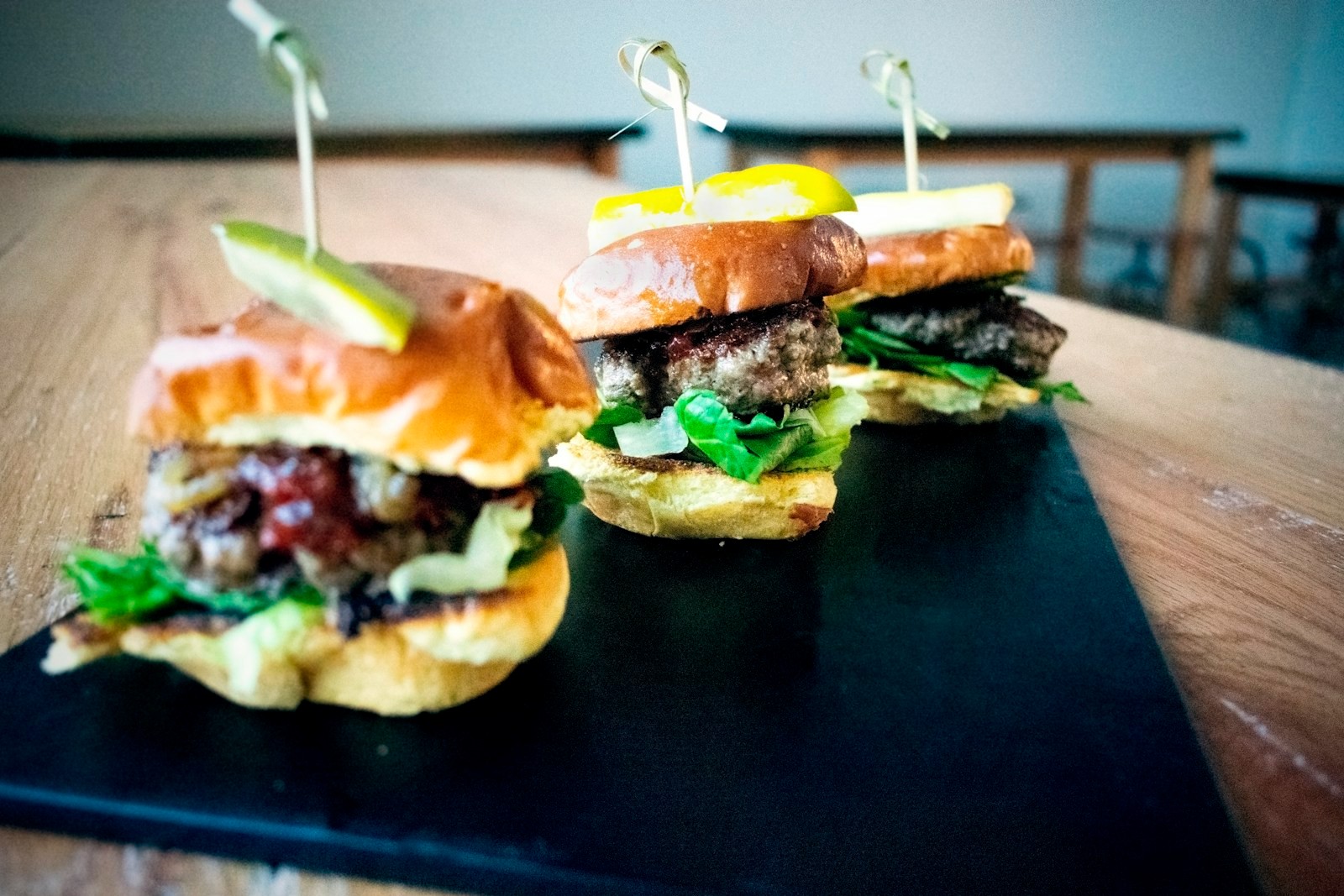 Chicken sliders with melted cheese on a slate board