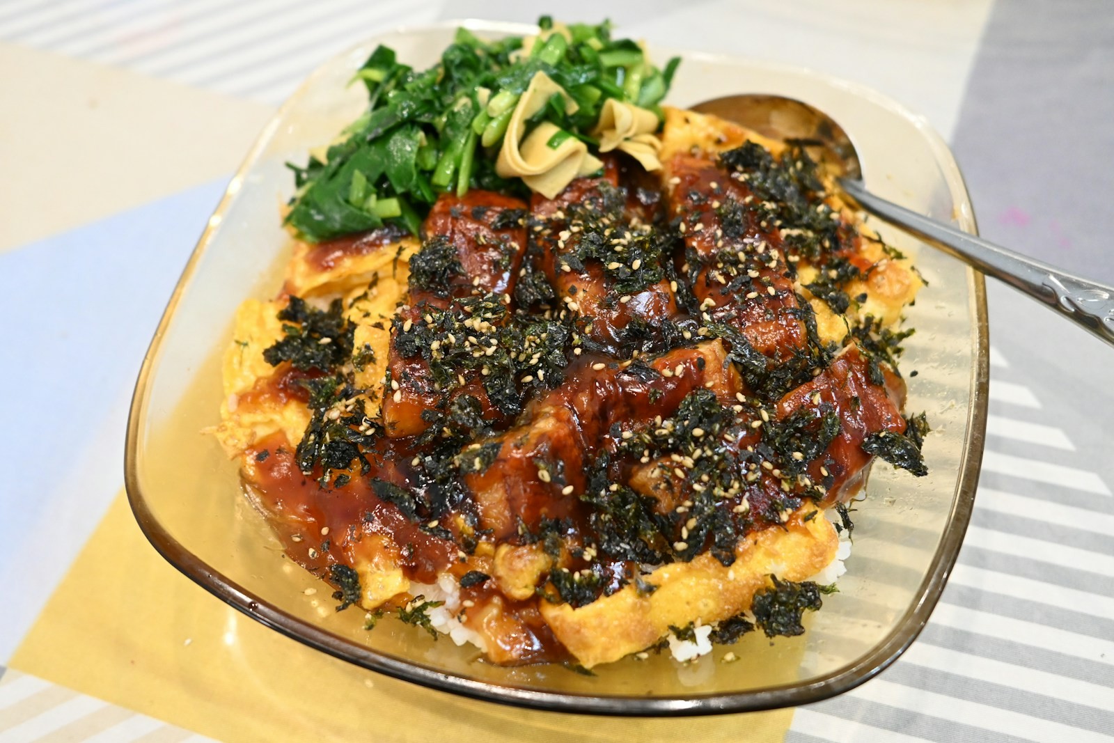 Sushi bake casserole, a TikTok dinner favorite, topped with furikake and eel sauce