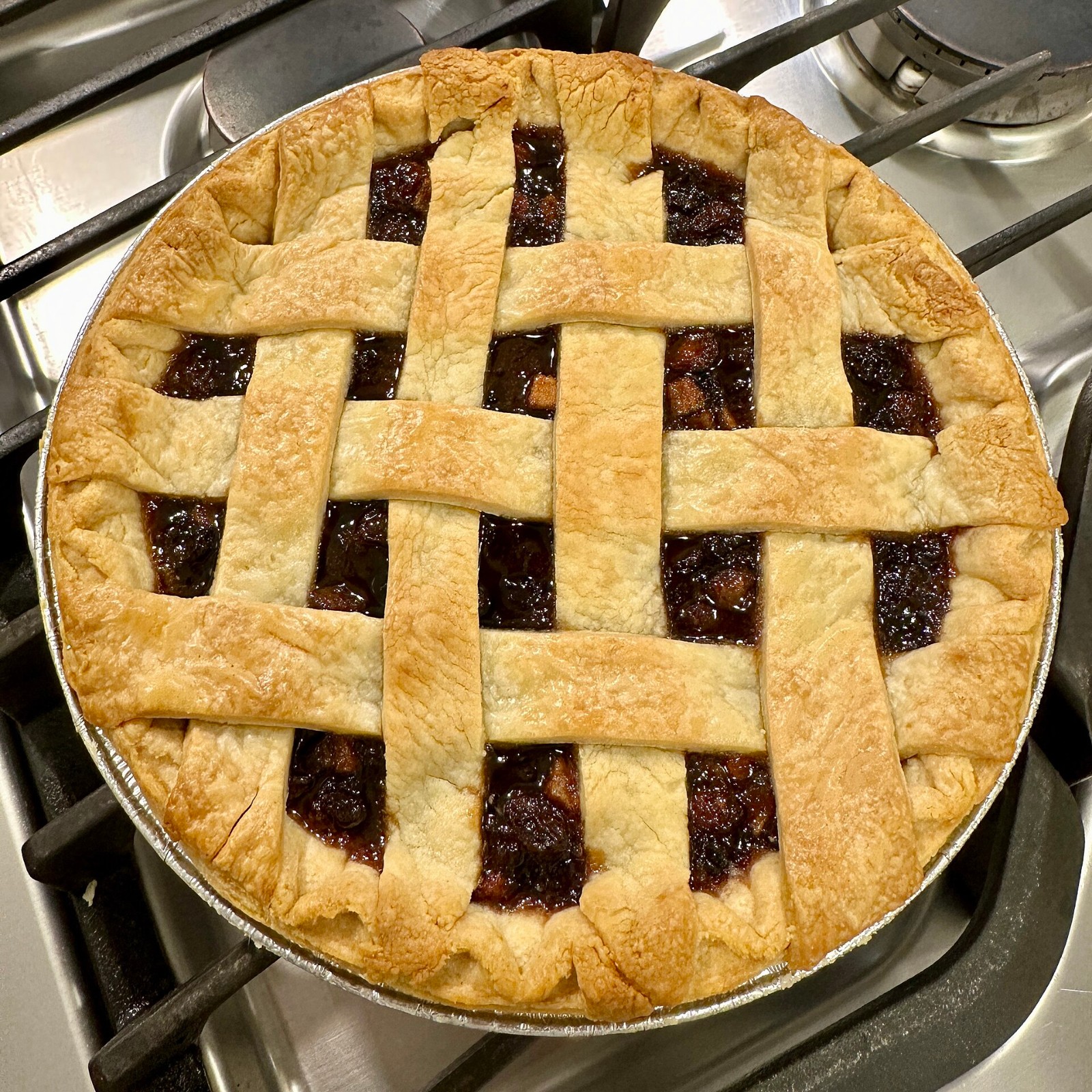 Lattice topped Christmas mincemeat pie with a dark fruit filling