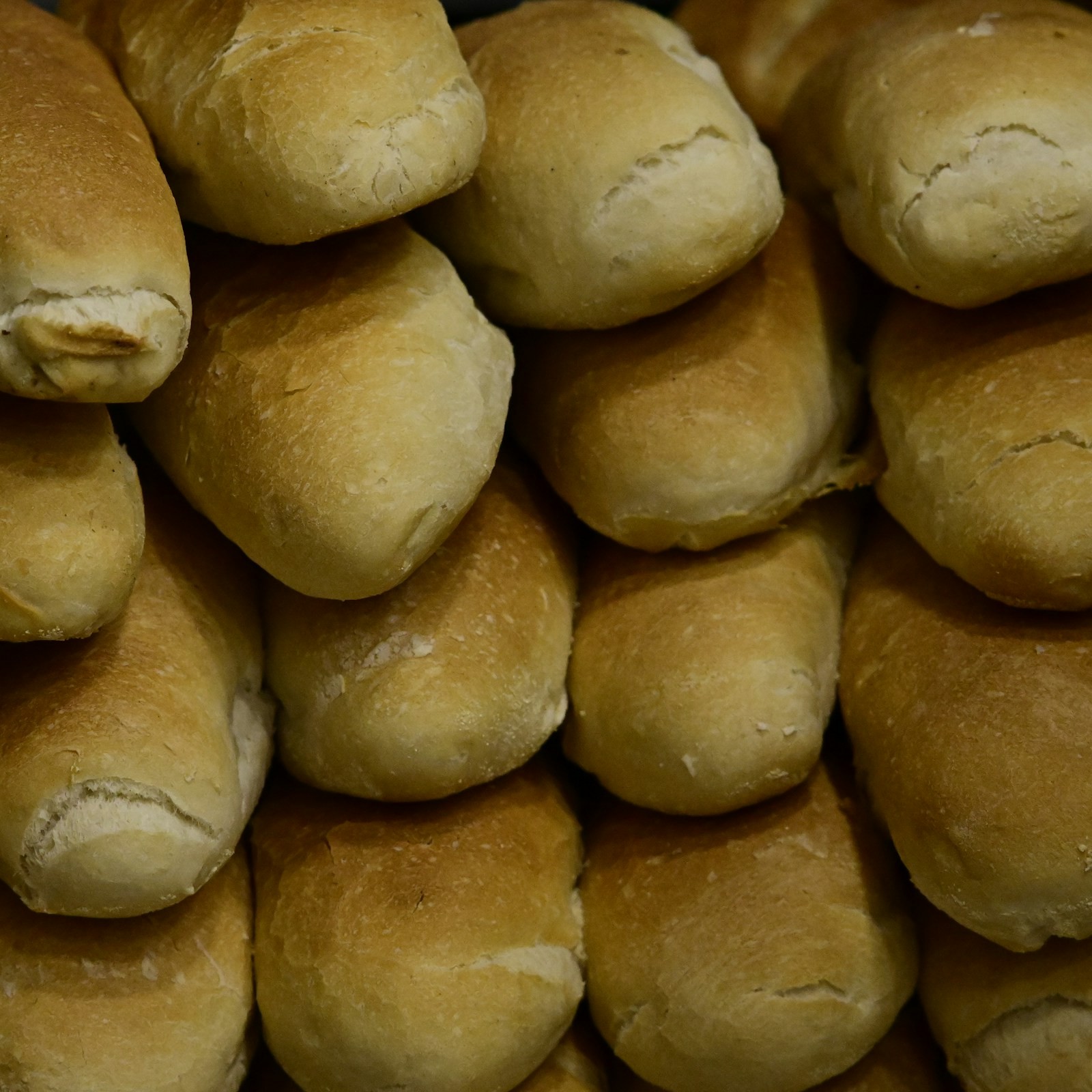Golden soft dinner rolls stacked together