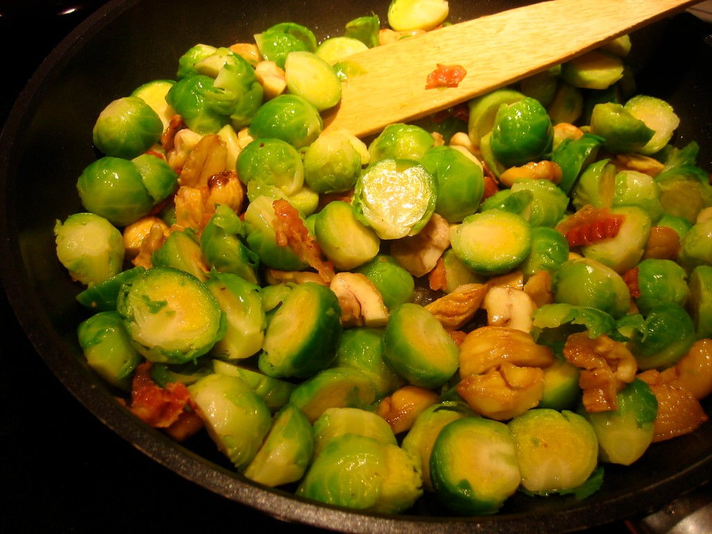 Roasted Brussels sprouts tossed in a hot pan