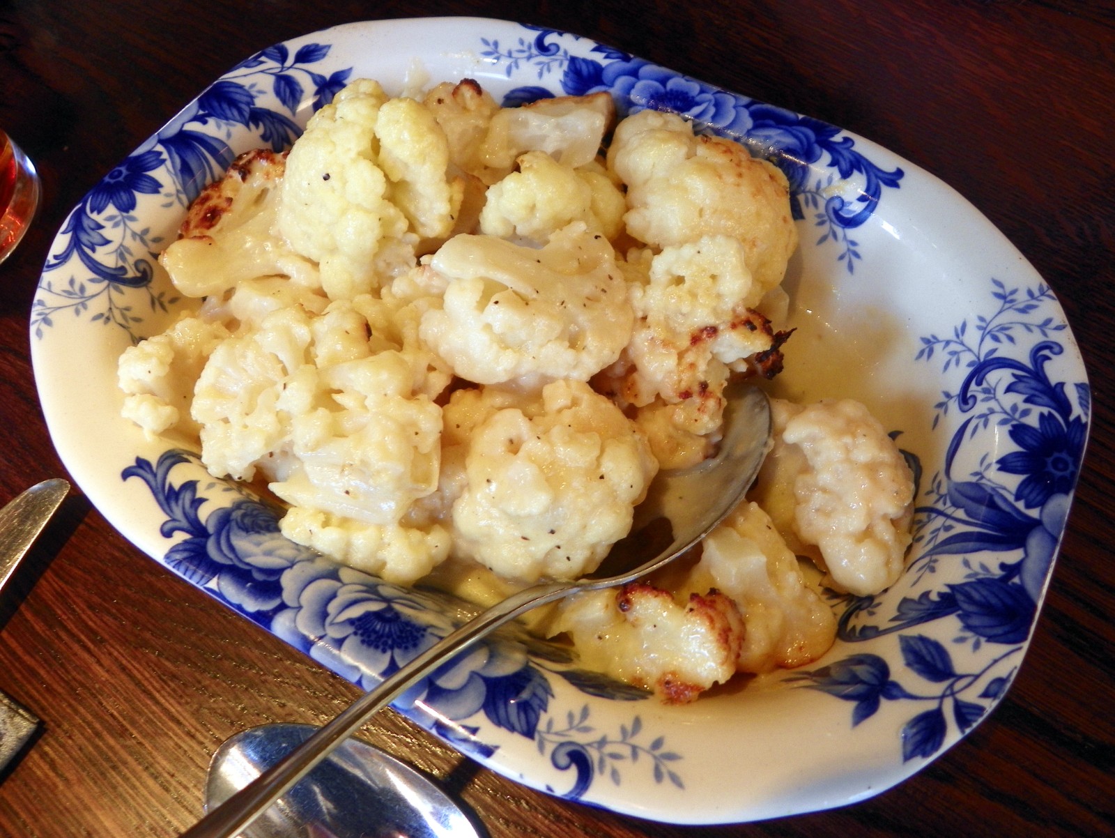 Baked cauliflower cheese with a bubbling golden crust