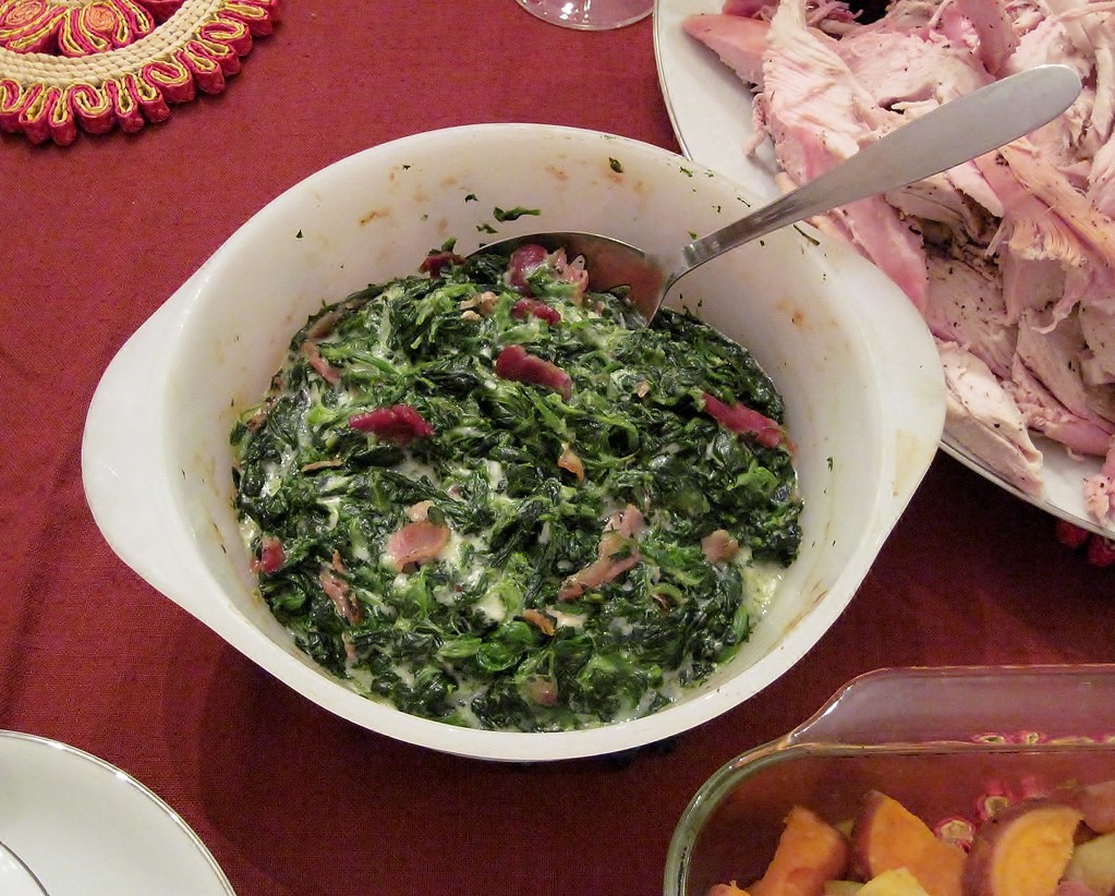 Creamy spinach side dish in a white bowl