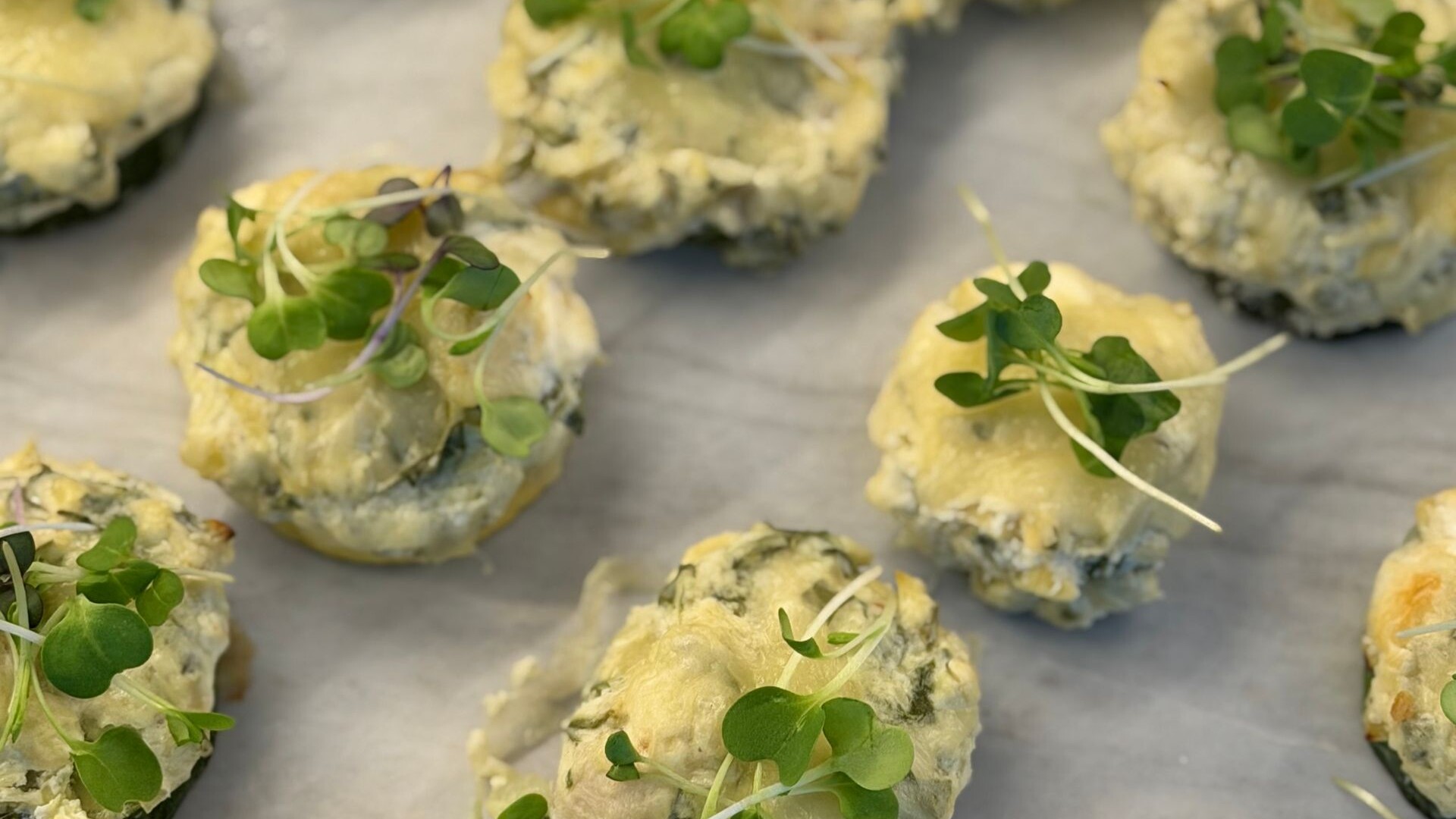 Baked stuffed mushrooms topped with microgreens
