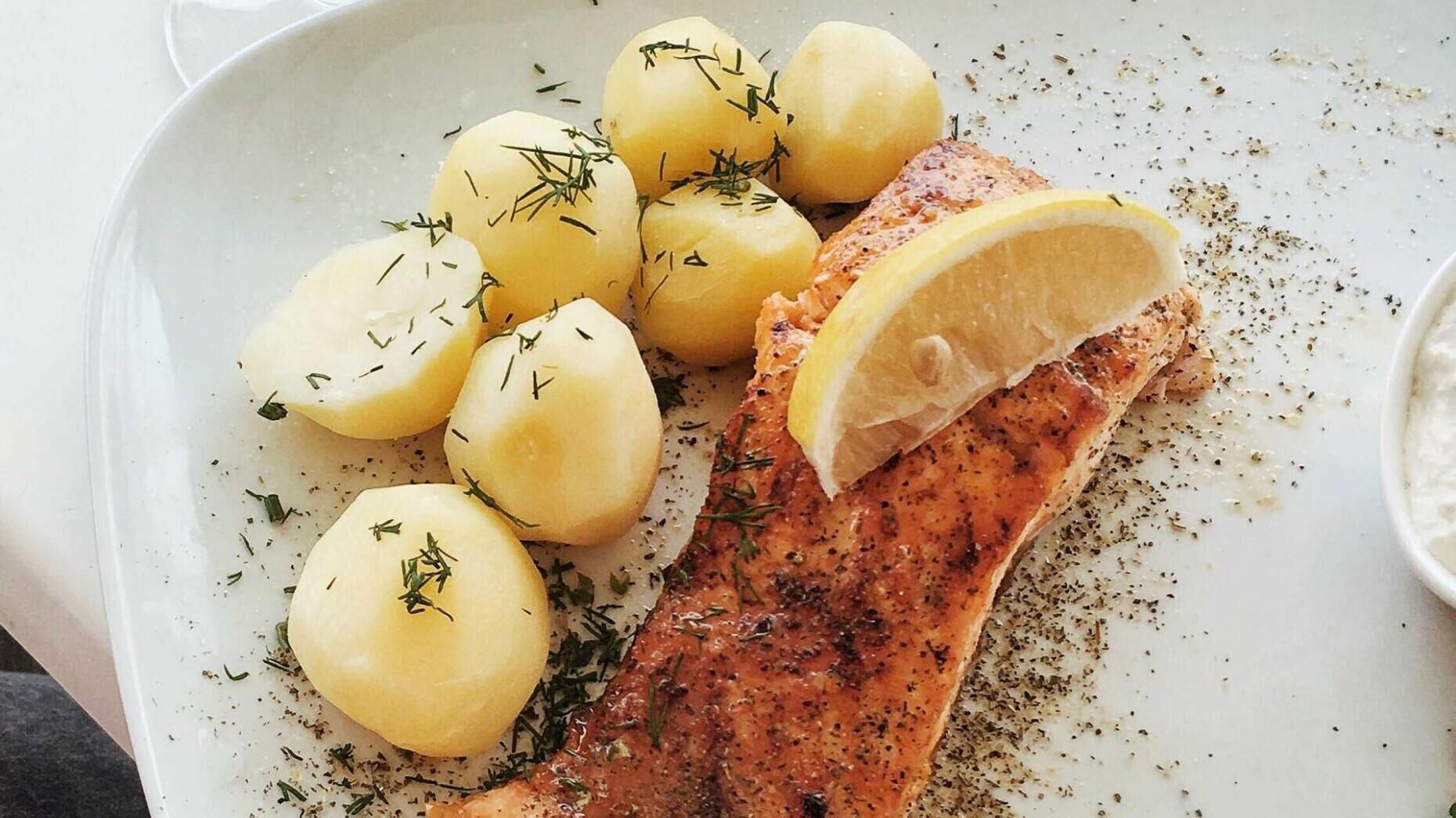 Baked salmon fillet with baby potatoes, lemon and dill