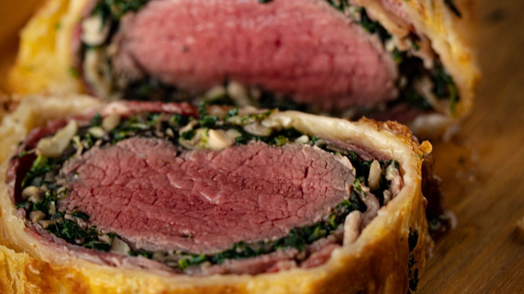 Christmas dinner for two: sliced beef Wellington with a pink center and golden pastry
