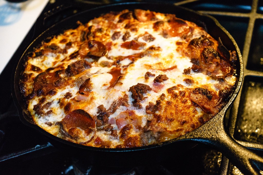 Deep dish style pizza baked in a cast iron skillet