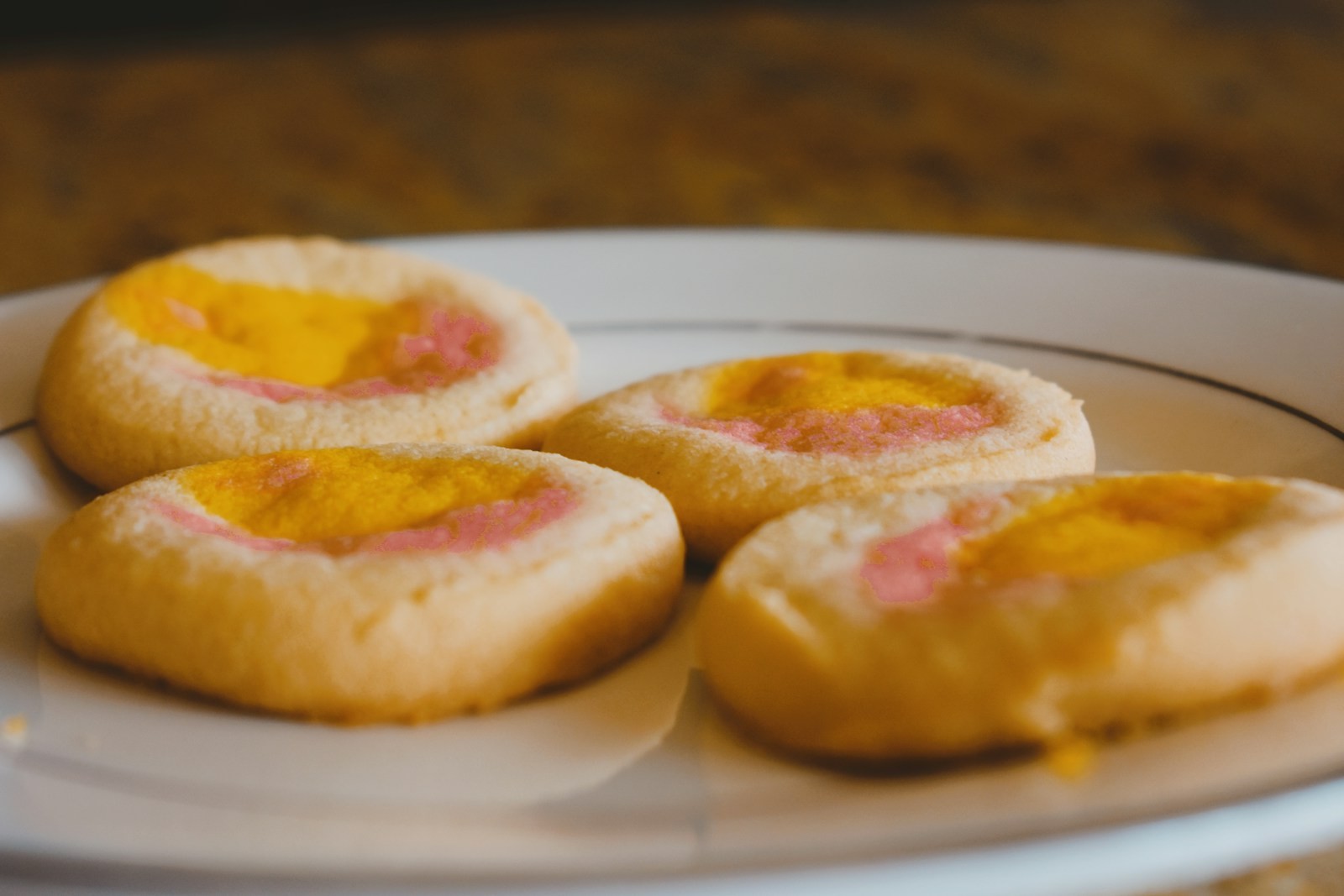 Jam thumbprint treats on a white plate