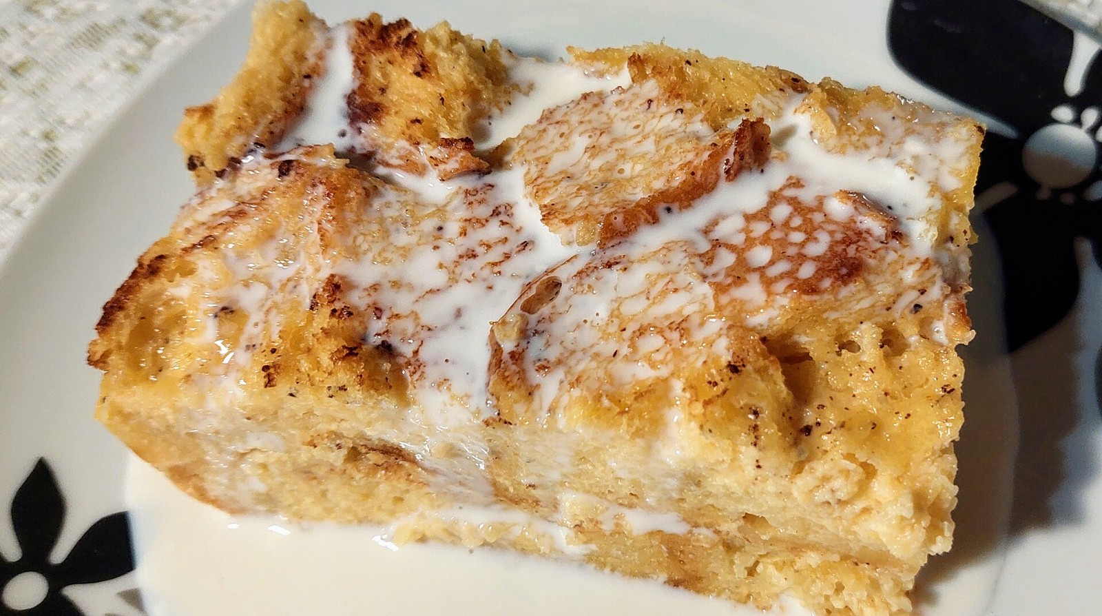 Baked bread pudding with vanilla sauce