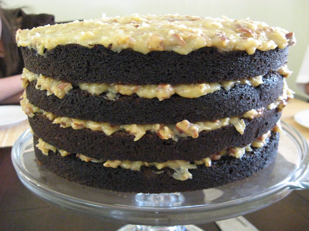 German chocolate cake topped with coconut pecan frosting