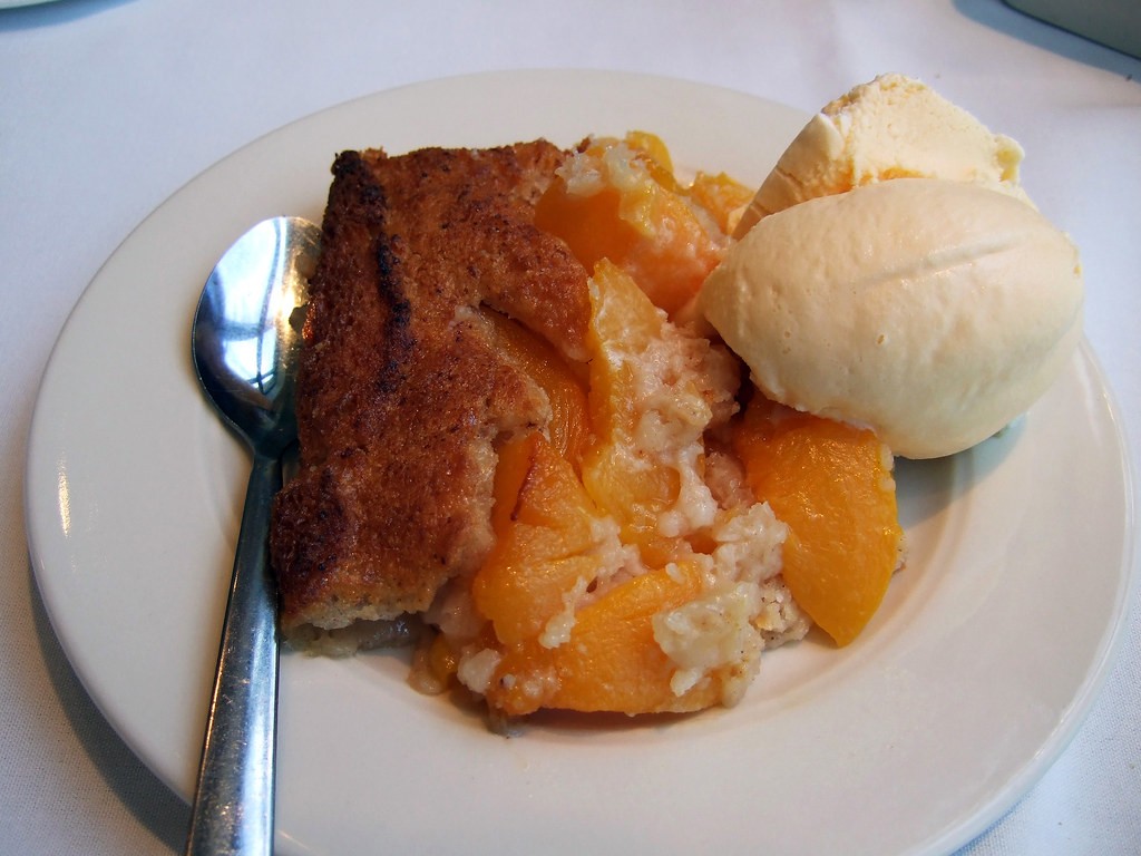 Peach cobbler served with vanilla ice cream