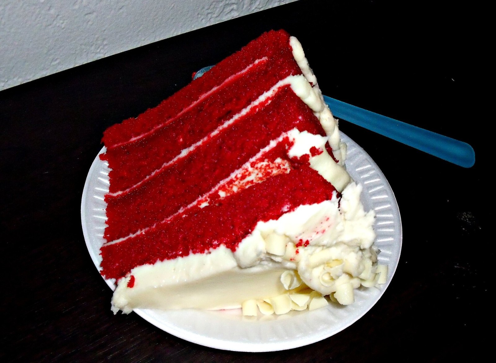 Slice of red velvet layer cake with cream cheese frosting