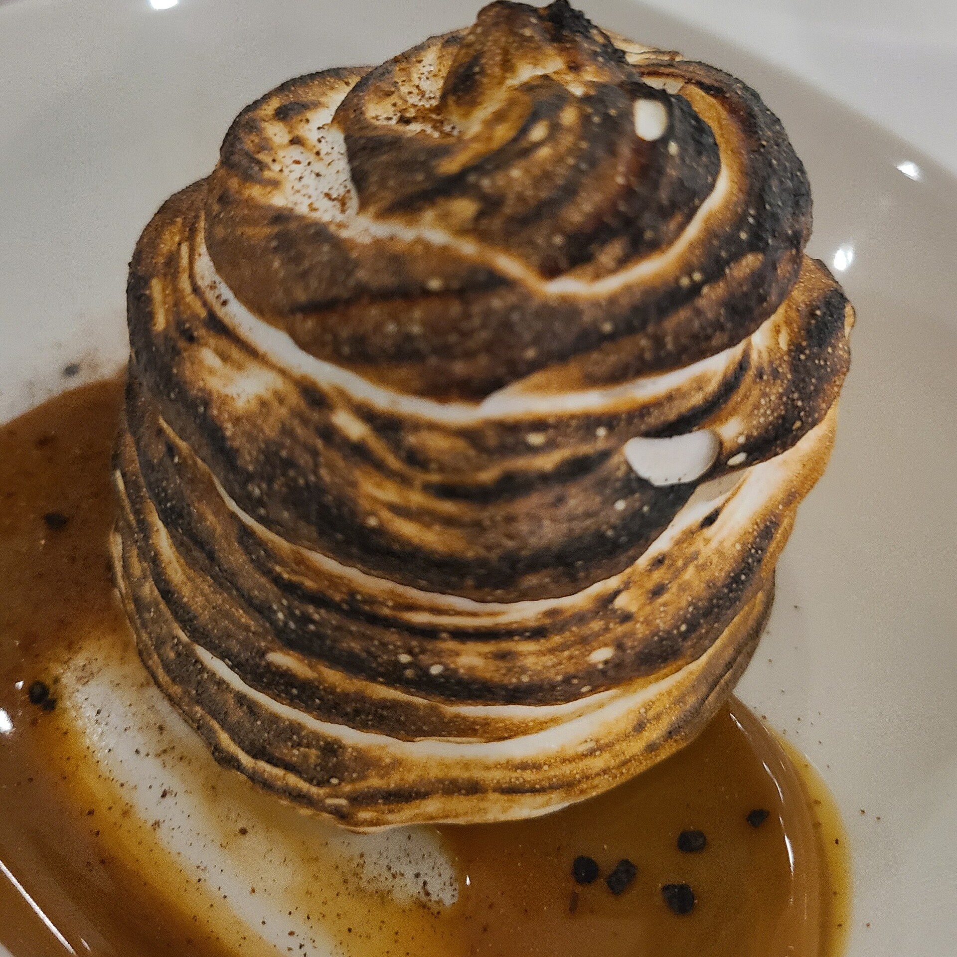 Baked Alaska with browned meringue swirls on a plate
