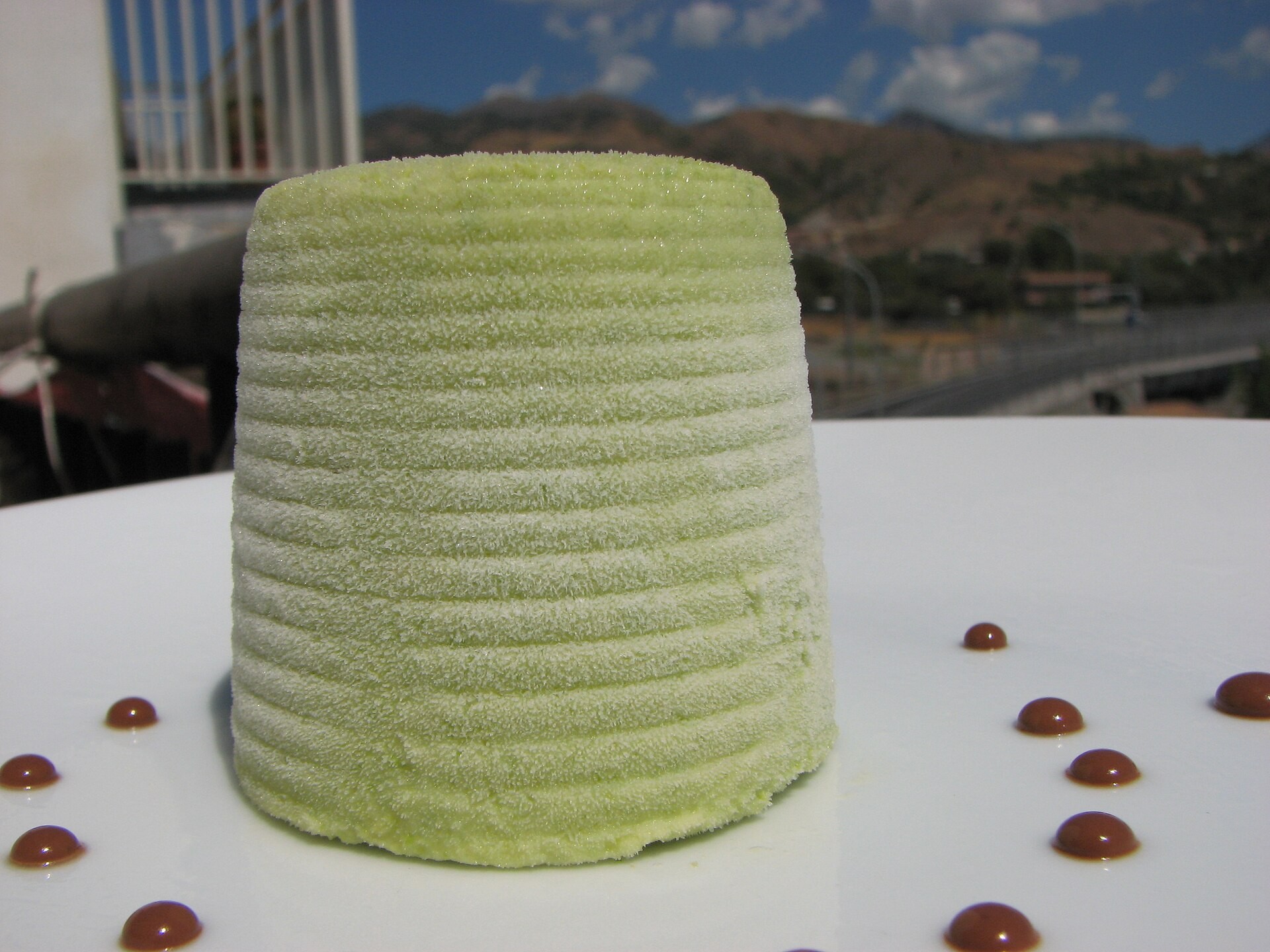 Pistachio semifreddo dome on a white plate