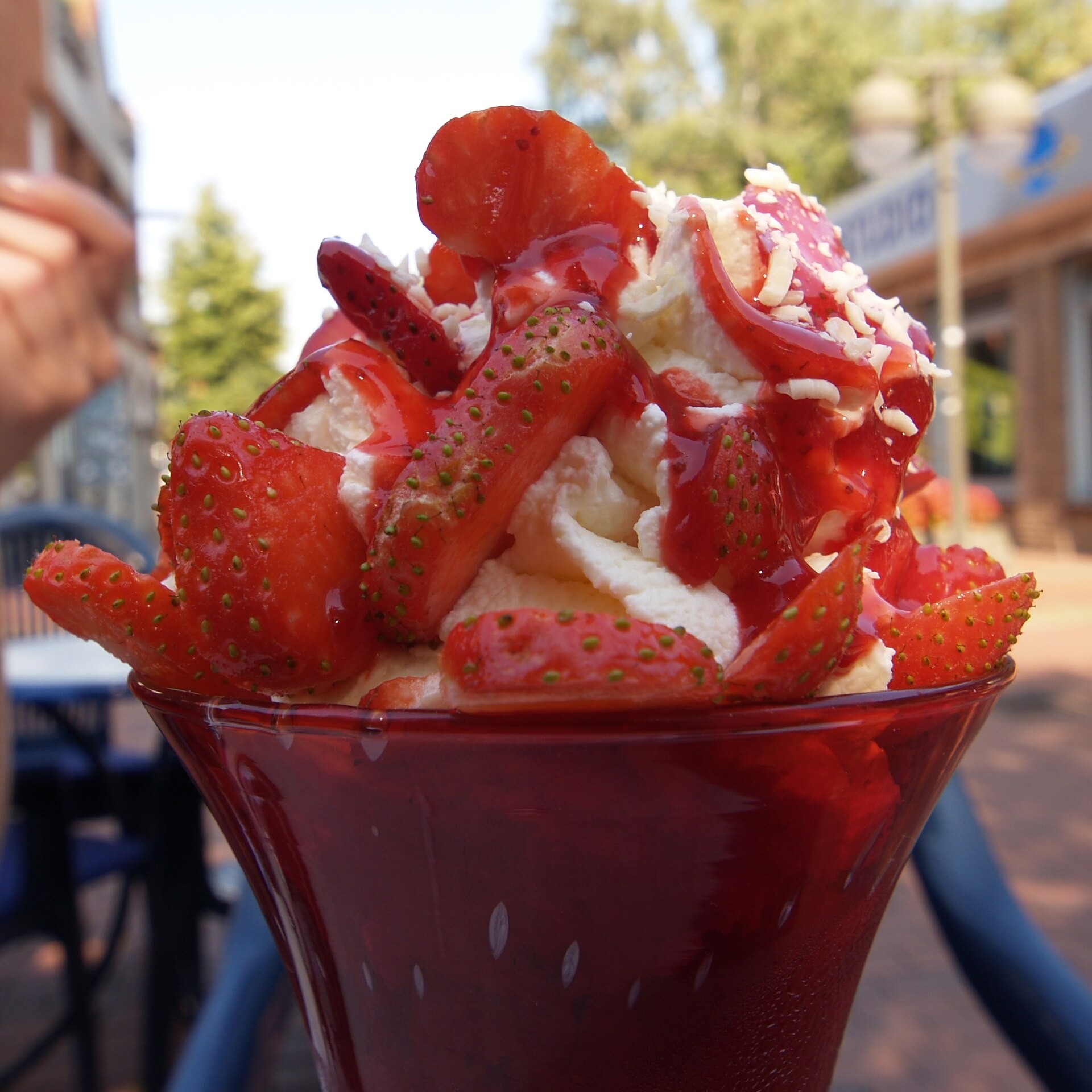 Christmas ice cream desserts sundae with strawberries, whipped cream and pink candy