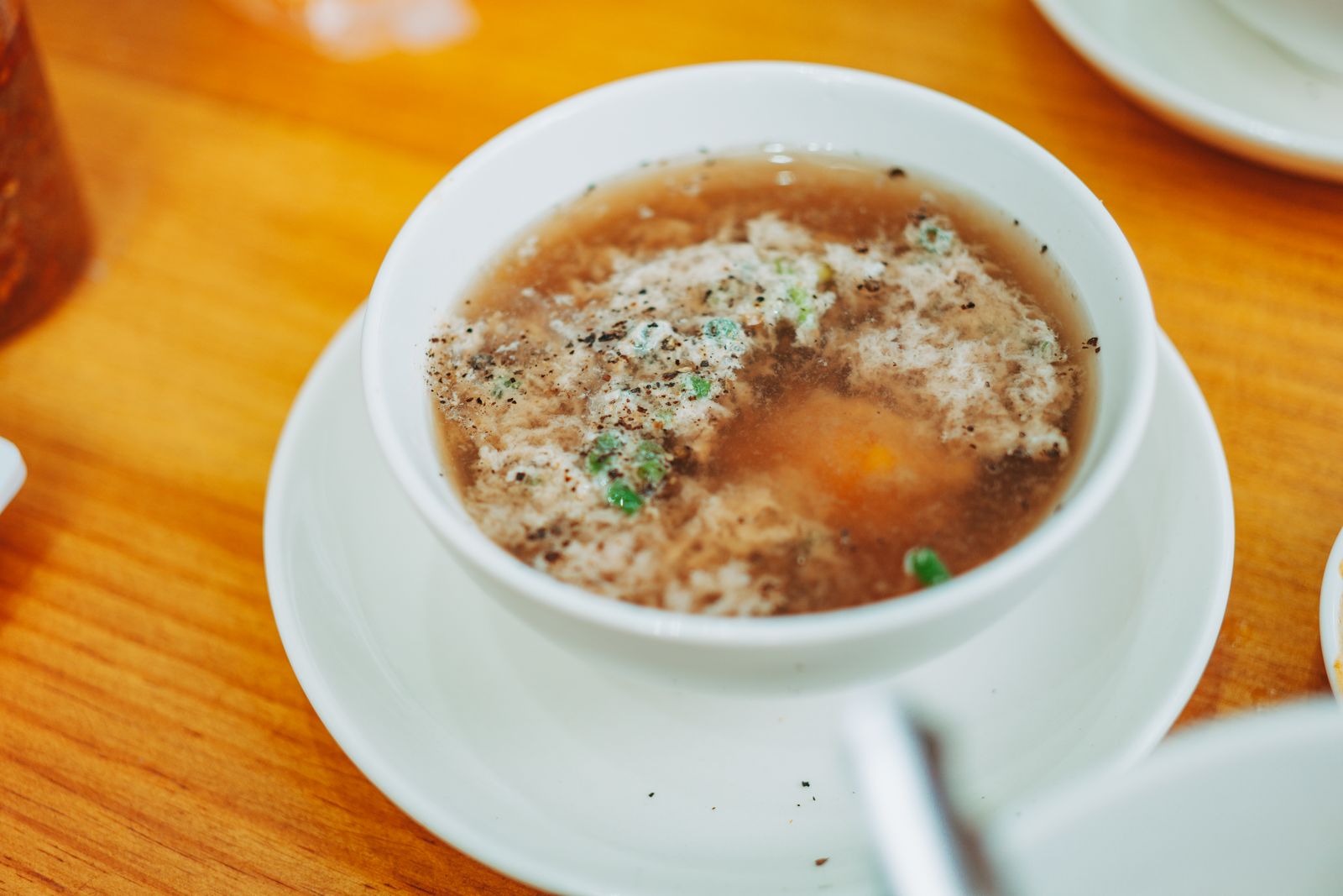 Egg drop soup in a white bowl