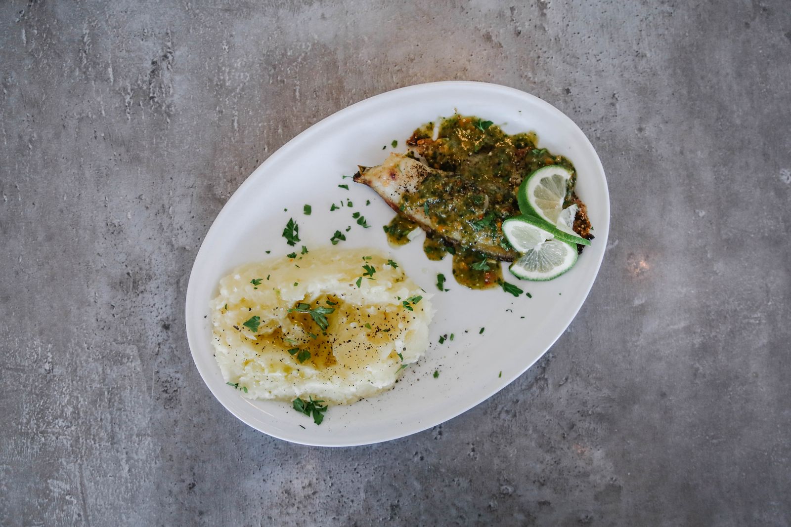 White fish with herb sauce and mashed potatoes