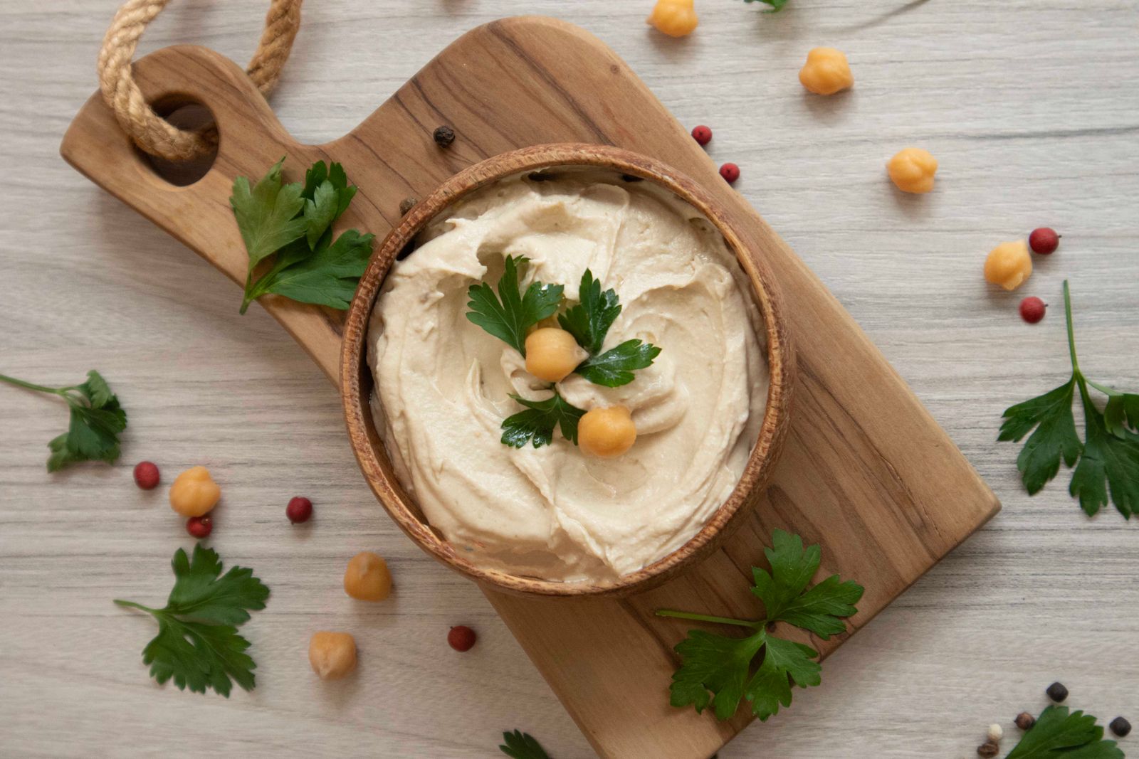 Creamy homemade hummus with chickpeas and parsley