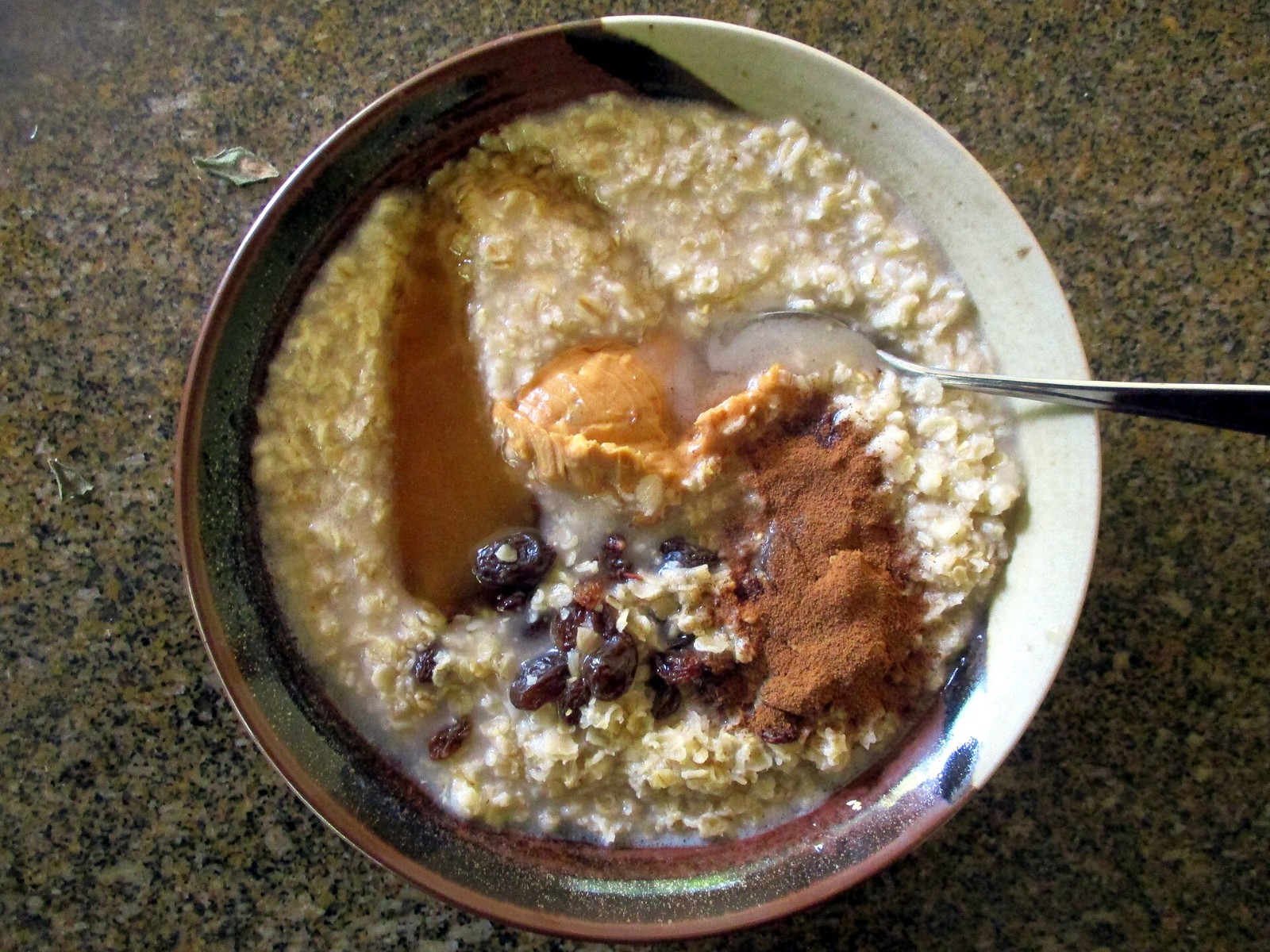 Depression era breakfast bowl of oatmeal with dried fruit and brown sugar
