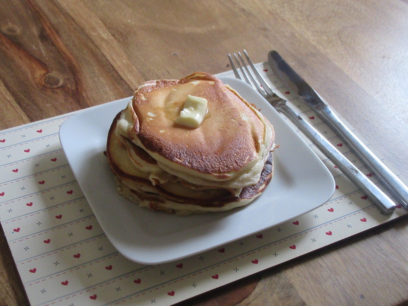 Stack of thin homemade pancakes with melting butter