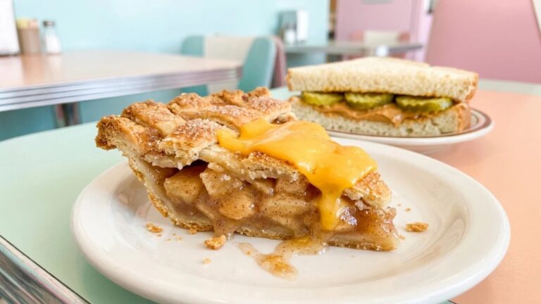 A slice of apple pie with melted cheddar and a peanut butter pickle sandwich